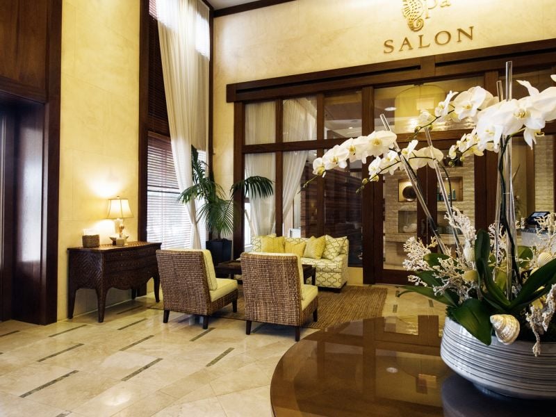 Floral arrangement inside the spa lobby with sitting area in the background